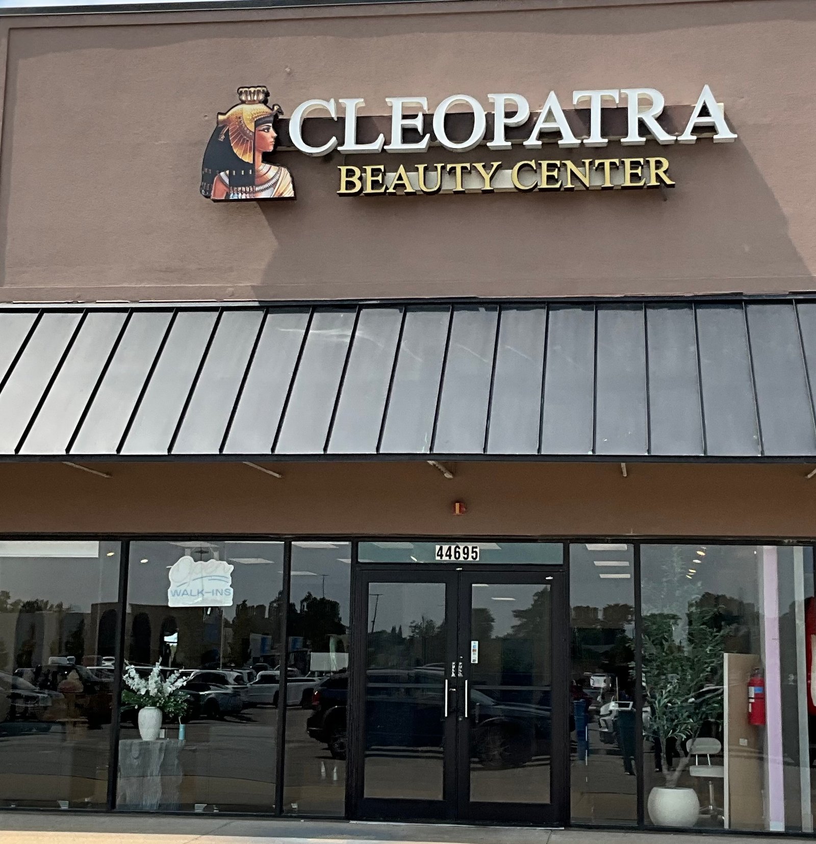 Cleopatra Beauty Center luxury salon storefront exterior building façade at 44695 Mound Road in Sterling Heights, Michigan, offering premium balayage, blonde hair highlights, and high-glamour bridal makeup services.