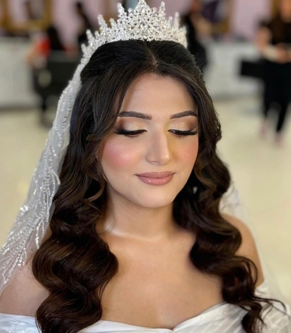High-glamour bridal makeup, royal tiara styling, and elegant Hollywood waves by Cleopatra Beauty Center in Sterling Heights, Michigan.